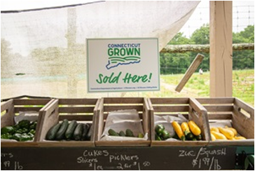 baskets of vegetables with sign stating CT Grown sold here